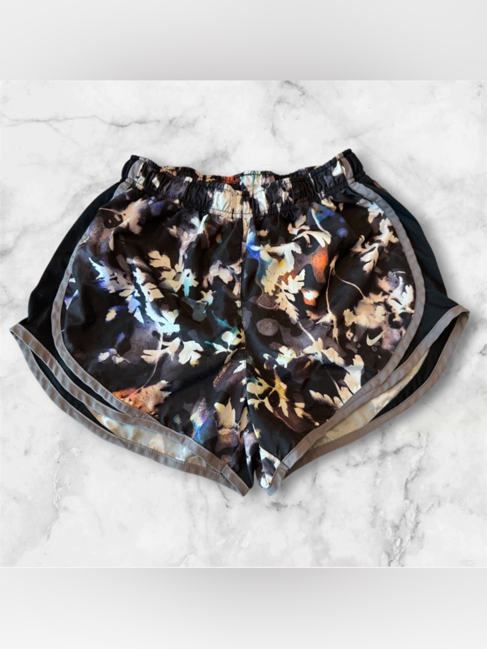 Nike Dri-FIT running shorts with a floral abstract print and an interior liner